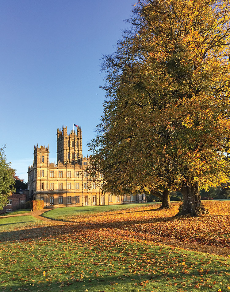 On the grounds of this renowned estate, fall foliage acts as a red carpet leading the way to Highclere Castle and its iconic façade.