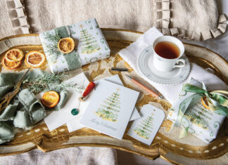 Wrapped in Bliss: Victoria X Dogwood Hill: An antique Italian tray showcases tea, gift cards, gift tags, and packages wrapped in Blissful Holiday Collection gift wrap.