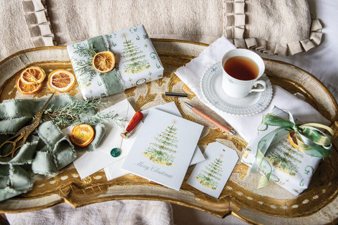 Wrapped in Bliss: Victoria X Dogwood Hill: An antique Italian tray showcases tea, gift cards, gift tags, and packages wrapped in Blissful Holiday Collection gift wrap.