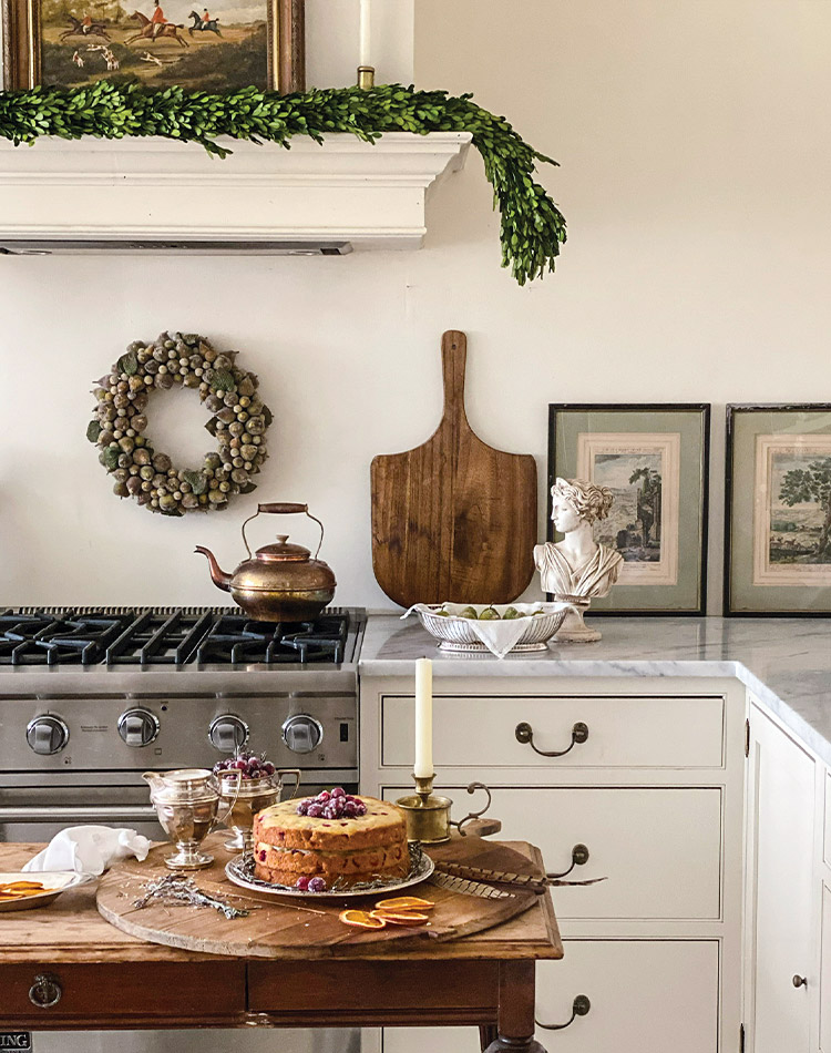 In Jenny Bohannon’s white-hued kitchen, an orange-and-cranberry layer cake rests atop a silver cake plate on the kitchen island.