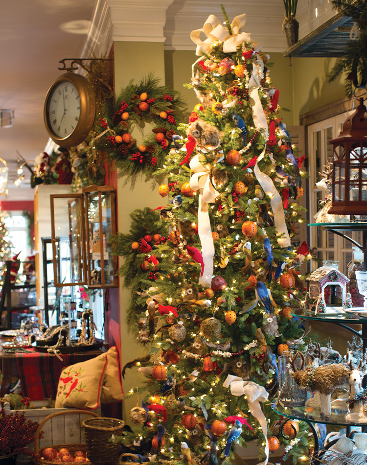 A lavishly decorated Christmas tree in the cozy heart of Seasons of Williamsburg shop.