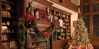 Holiday Bliss 2023 Preview. A decked mantle piece sits in the glow of a decorated Christmas tree.