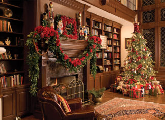 Holiday Bliss 2023 Preview. A decked mantle piece sits in the glow of a decorated Christmas tree.