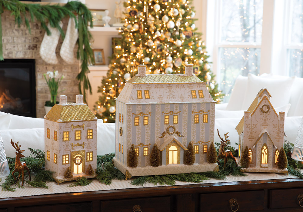 On a side table in the living room, Maribel Polanco’s handiwork—papier-mâché houses dressed in pastel and gold—are displayed against the background of a twinkling tree.