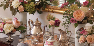 A silver tea service sits atop a wooden table, awaiting the finery of the experience that is afternoon tea.