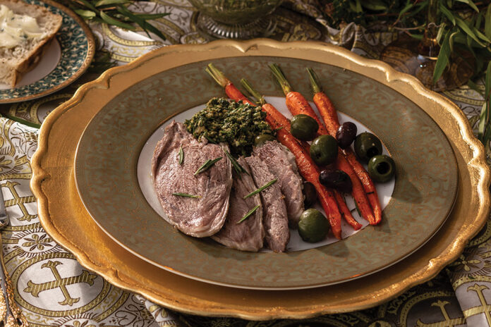 For a hearty entrée, we serve Roasted Leg of Lamb, flavored with woodsy rosemary and the bright citrus of orange zest. The bone-in cut cooks alongside mixed olives and baby carrots and is plated with these tasty components and refreshing carrot-mint pesto.