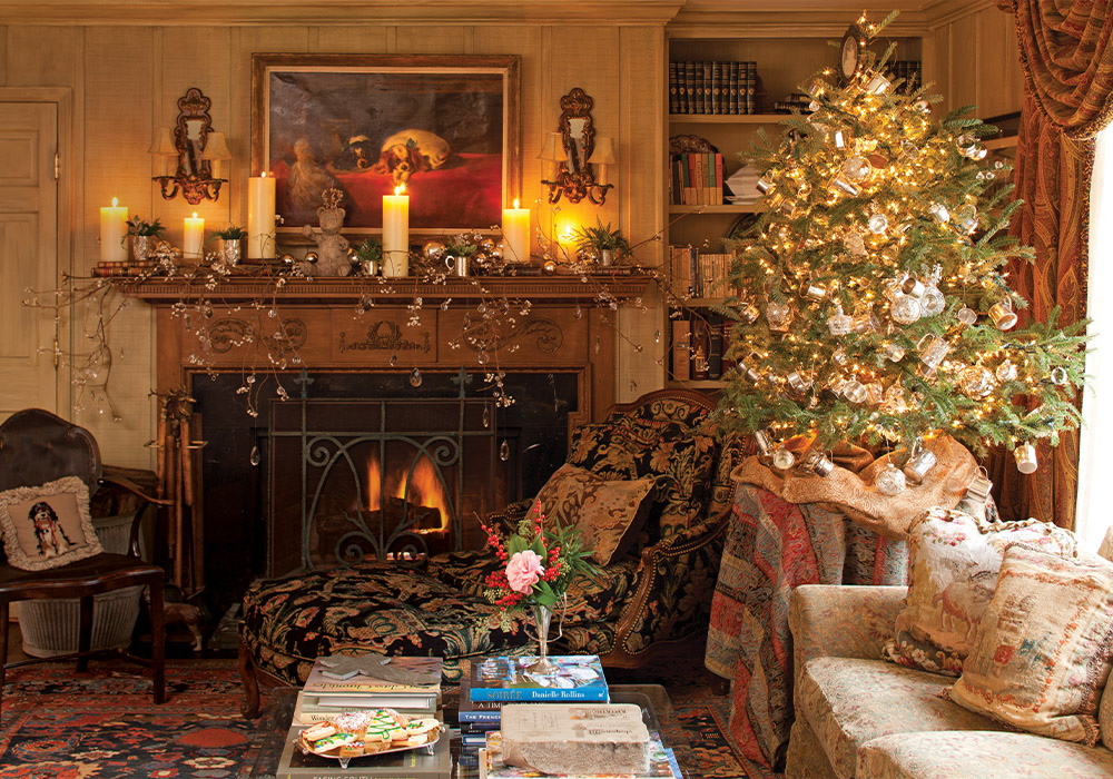 Floral designer Jon Martinez dressed the fireplace mantel with cut branches laced with crystal beads, ivory pillar candles, and a collection of silver celebration cups that document the births of the homeowner’s grandchildren. 