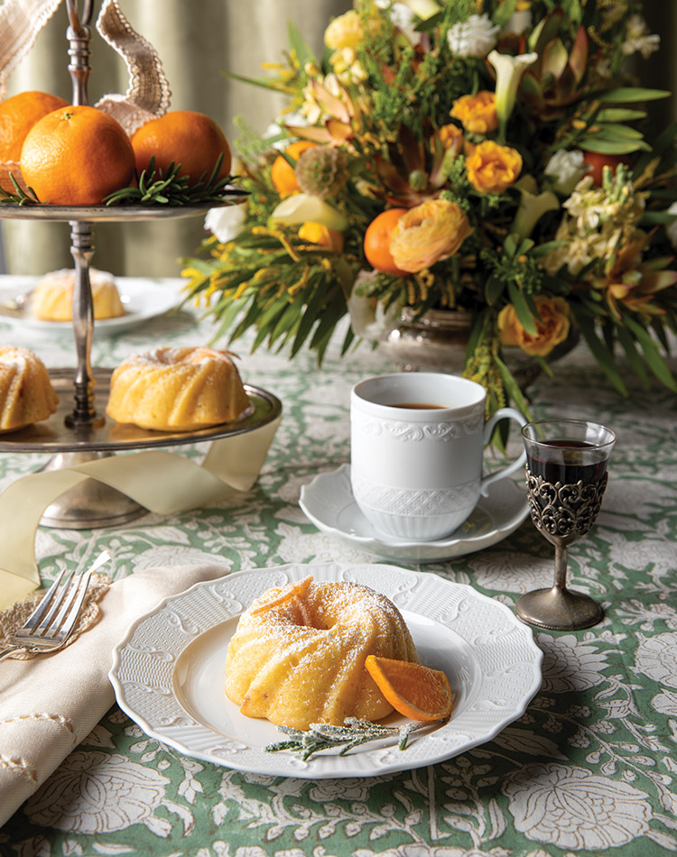 A tiered tray presents not only miniature olive oil Bundt cakes, but also the tangerines that flavored them.