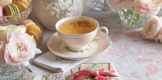 A pink blush covers this tea table, dressed with feminine china, pale roses, and Valentine cards.