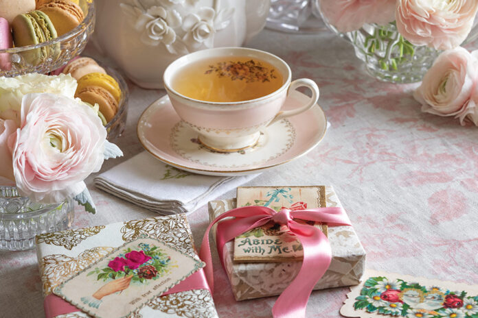 A pink blush covers this tea table, dressed with feminine china, pale roses, and Valentine cards.