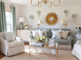 The formal living room designed by Tuft & Trim is a green-and-white haven brimming with vintage style and gold finishes.
