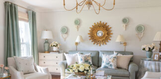 The formal living room designed by Tuft & Trim is a green-and-white haven brimming with vintage style and gold finishes.