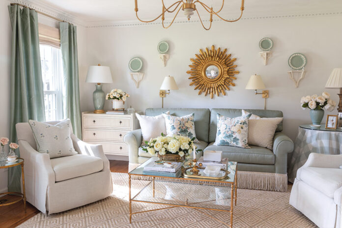 The formal living room designed by Tuft & Trim is a green-and-white haven brimming with vintage style and gold finishes.