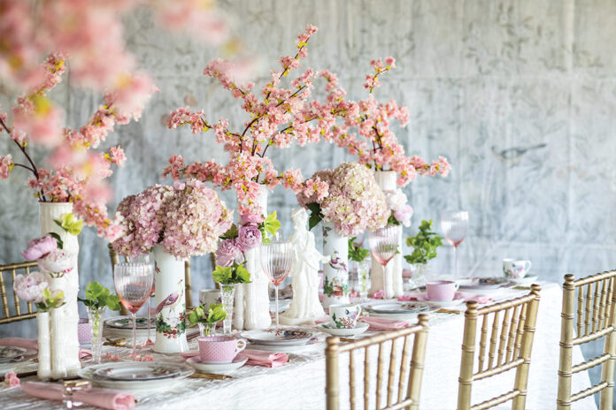 Victoria-Magazine-Cherry-Blossom-Tableau Victoria test kitchen chef Izzie Turner, who developed the recipes featured in “Among the Cherry Blossoms,” recommends these top ten pantry staples for forays into Asian cooking. Tall vases filled with clusters of cherry blossoms, hydrangeas, and peonies add springtime beauty to a table set for a feast of Japanese fare.