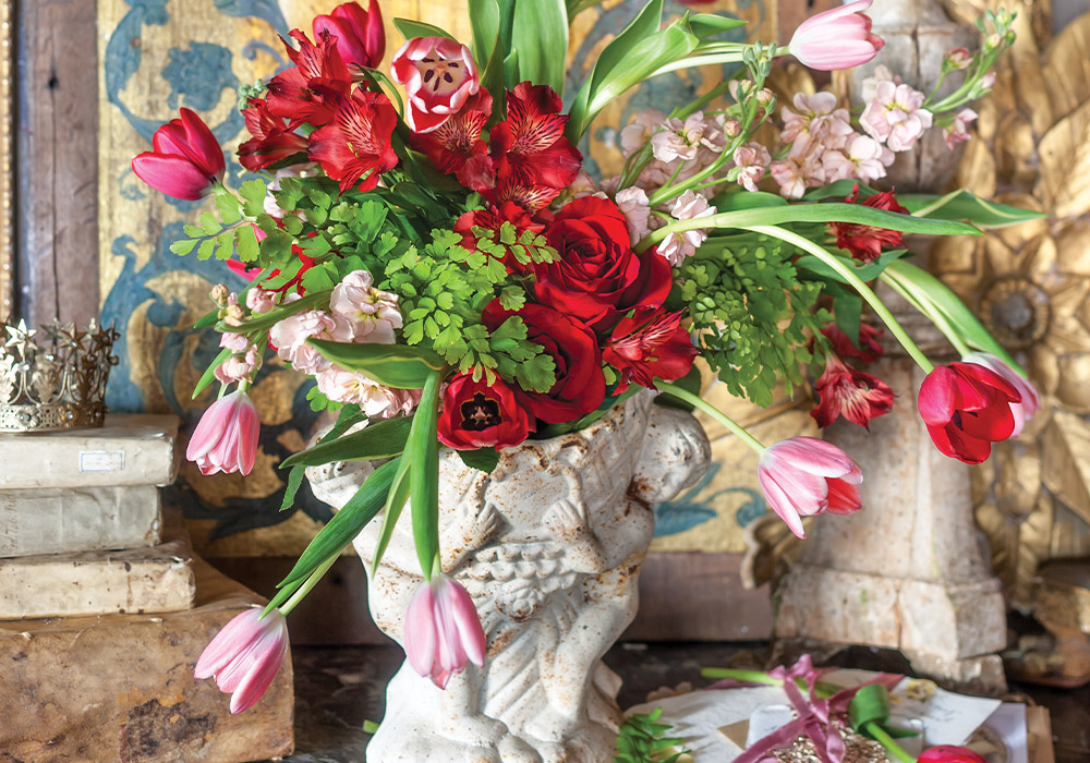 A carefully selected floral arrangement that includes red roses and scarlet tulips conveys the sentiment of true love.