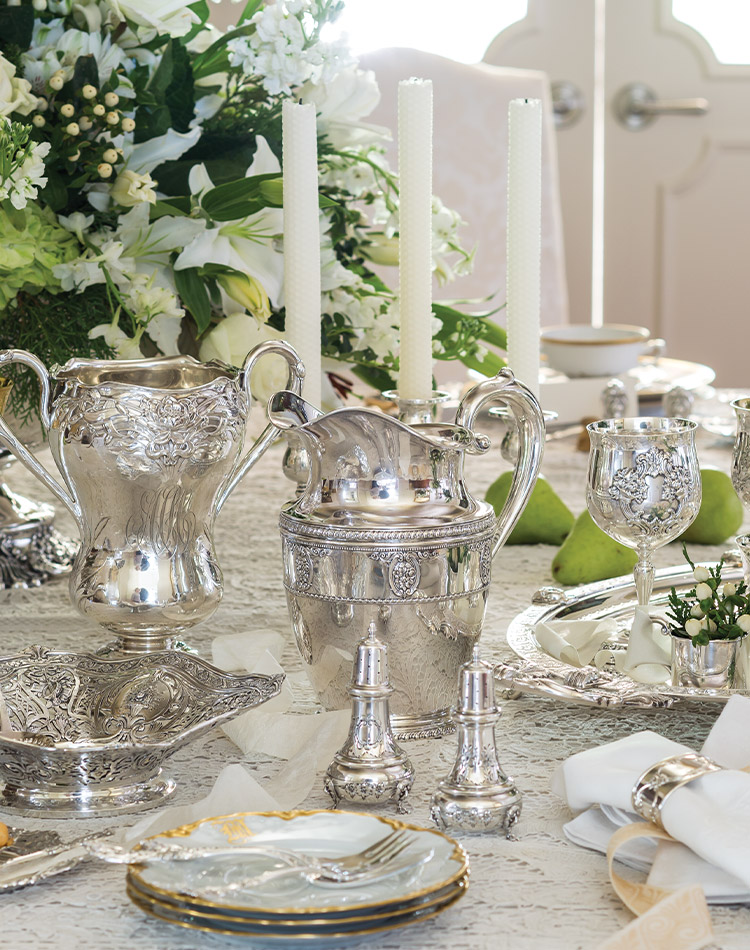 Polished to a lustrous sheen, a stunning collection of sterling silver graces the table.