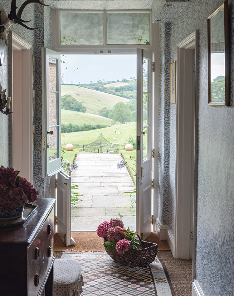 Standing inside Louise Townsend’s English cottage, one looks out the front door upon the rolling hills dotted with farm animals.