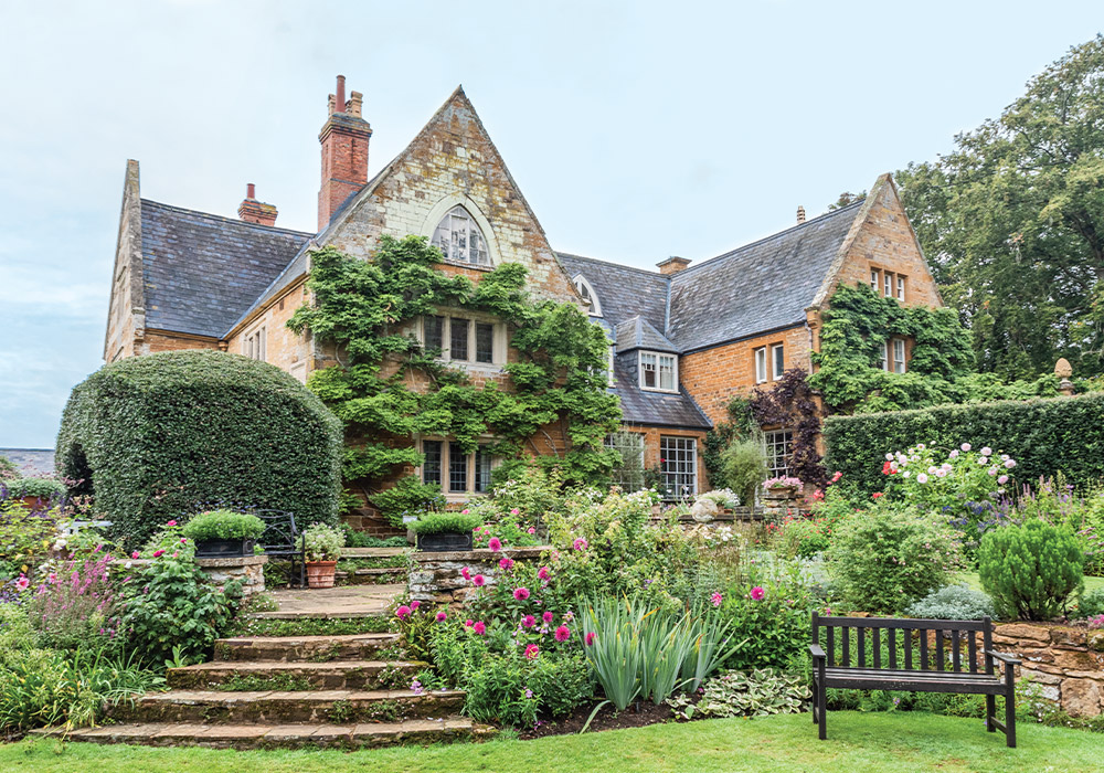 The ivy-clad façade of Coton Manor looks out upon the estate’s charming garden.
