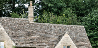 Preview Our Inviting English Cottage 2024 Special Issue: The walkway to the front door of this English cottage is lined with a profusion of flowers.