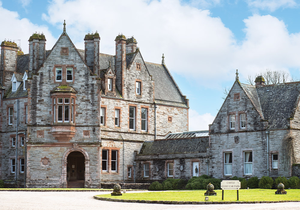 The stately façade of Castle Leslie is constructed of gray limestone with red sandstone and terra-cotta details.