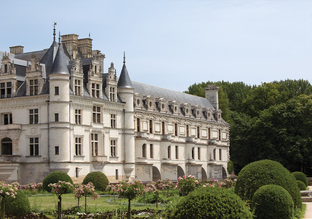 Viewed from the gardens, the exterior façade of Château de Chenonceau stands proudly above the river Cher.