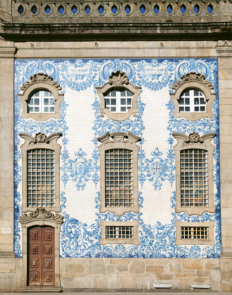 Blue-and-white tiles adorn the façade of this structure in Portugal, which graces the cover of Christine Chitnis’ book featured on our bookshelf.