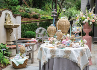 Here we offer an array of May Day ideas to revive pastoral fêtes. Set alongside a bubbling fountain in the ivy-laced cloister of a garden, a softly hued table is laden with spring blooms tucked into the basket of rattan hot air balloons, festive packages, and seasonal table settings.