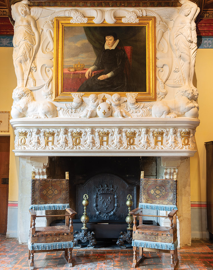In Diane de Poitiers’ chambers, a portrait of Catherine de’ Medici hangs above the fireplace, where gold symbols of Catherine and Henry II are engraved.