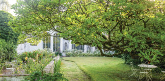 Pastoral greenery graces the property upon which this quaint abode rests.