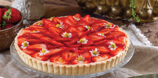 A few edible blooms top the sliced strawberries that fill Tartes aux Fraises.