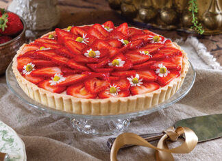 A few edible blooms top the sliced strawberries that fill Tartes aux Fraises.