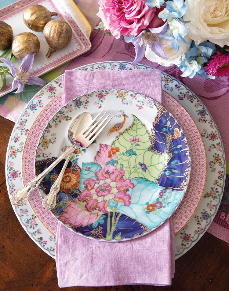 Golden figs rest on a nearby platter and vibrant pink and blue blooms spill forth from a vase, but the center of attention is still this breathtaking place setting from Mottahedeh, donned in bold floral imagery with gilt accents.