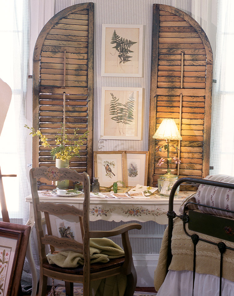 Cottages shutters stand over a humble vanity, framing images of nature.