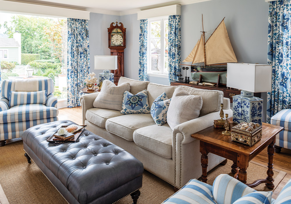 A coastal cottage's welcoming den reflects the blue tides and sandy dunes in paint, décor, and charm.