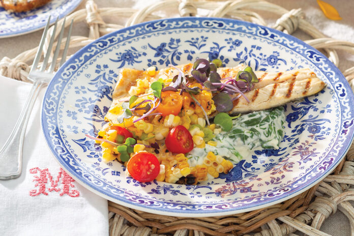 Grilled Trout with Corn-and-Tomato Salsa and Creamed Spinach tastes all the more satisfying when served in an alfresco setting.