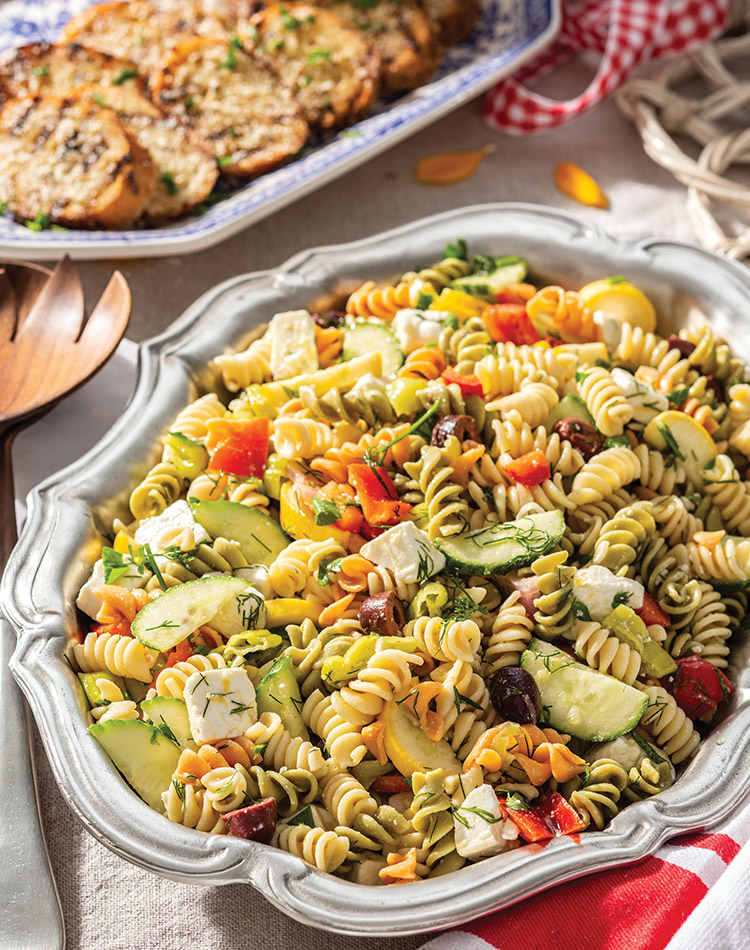 Multicolor rotini echoes the rainbow of hues in Zesty Pasta Salad, boasting summer squash, red bell pepper, cucumber, and kalamata olives.