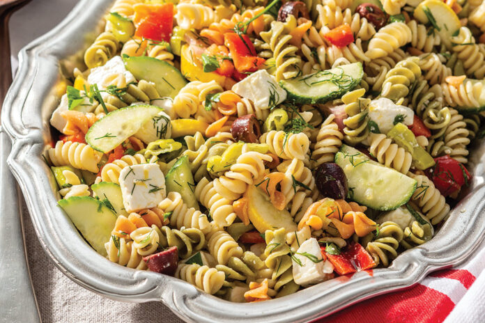 Multicolor rotini echoes the rainbow of hues in Zesty Pasta Salad, boasting summer squash, red bell pepper, cucumber, and kalamata olives.
