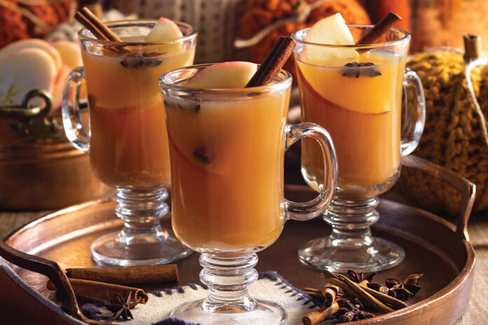 Unique glasses with quaint handles offer the perfect home for servings of mulled cider, with sticks of cinnamon, slices of apple, and star anise floating at the top.