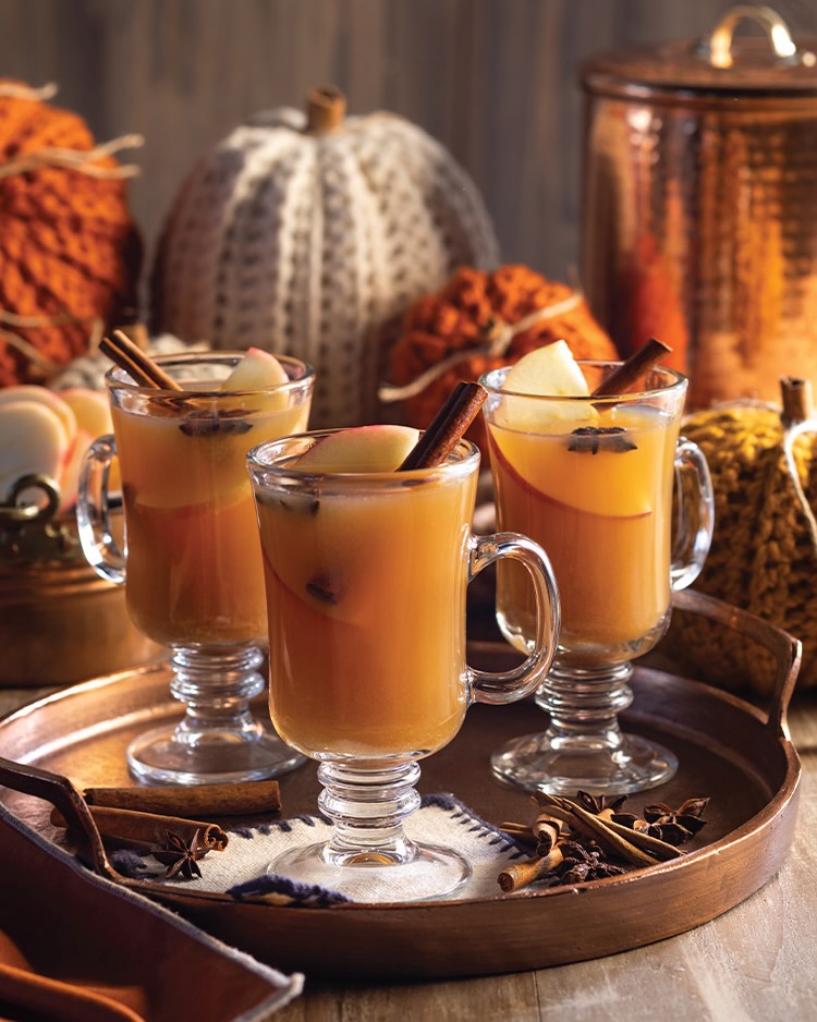 Unique glasses with quaint handles offer the perfect home for servings of mulled cider, with sticks of cinnamon, slices of apple, and star anise floating at the top.