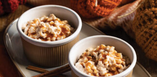 Sticks of cinnamon and a bowl of the spice are served beside deliciously creamy rice pudding.