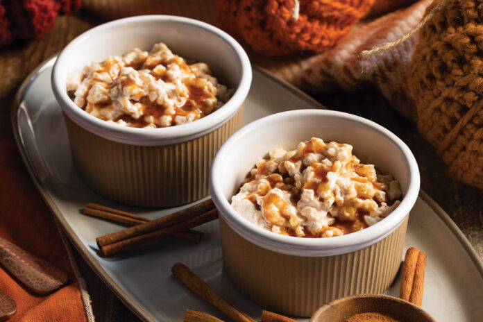 Sticks of cinnamon and a bowl of the spice are served beside deliciously creamy rice pudding.