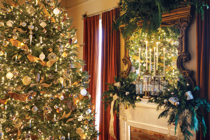 A gold-trimmed Christmas tree, velvet drapes, and a gilded overmantel mirror washed in fresh greenery all greet the holiday season in this historic home.