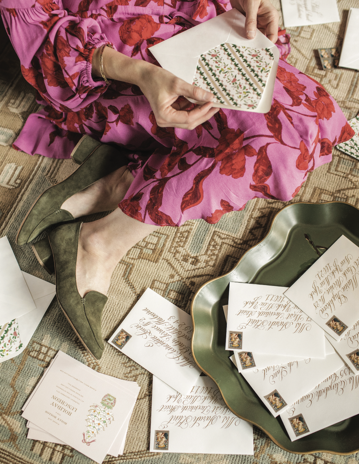 A woman sits surrounded by letters.
