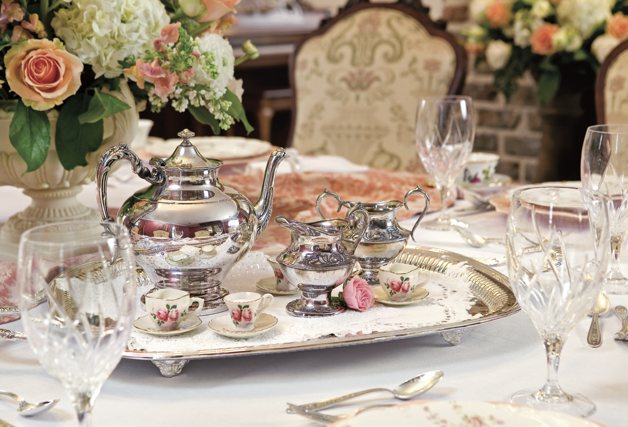 A silver tea set on a tray.