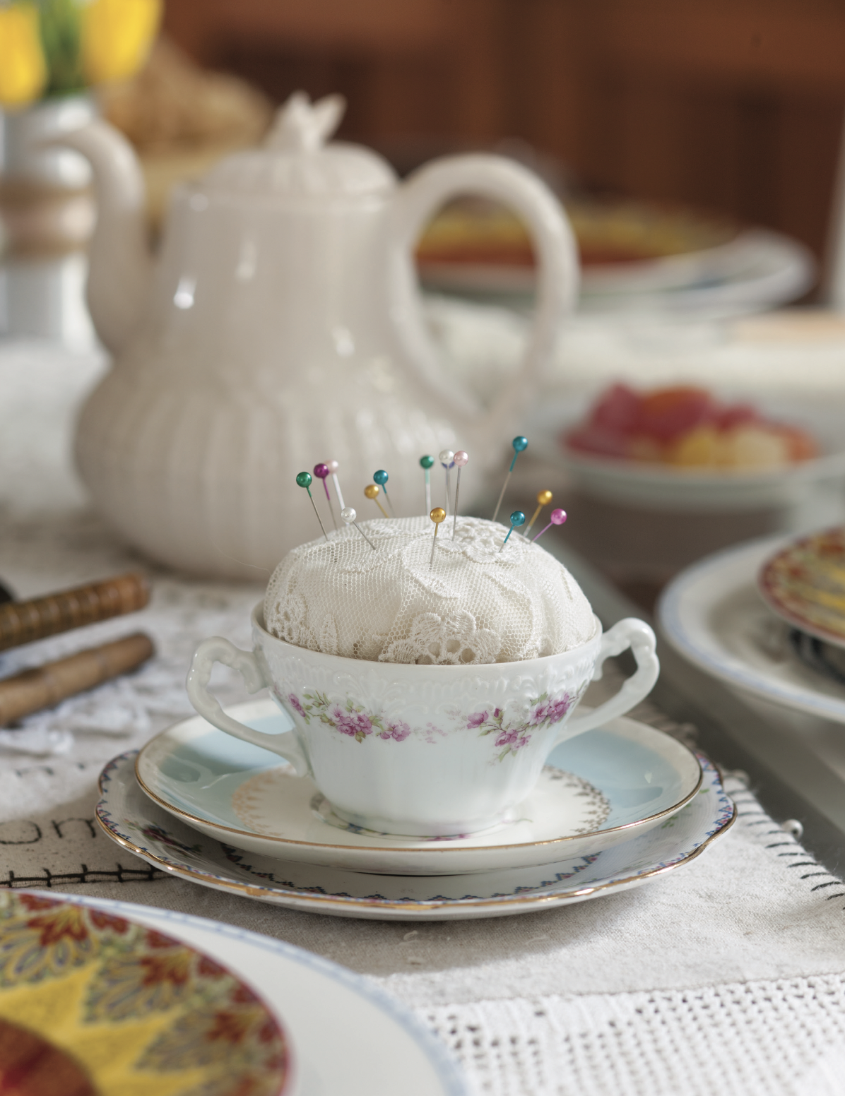 A tea cup pincushion.