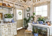A garden shed adorned with blue-and-white chinoiserie pieces and winter greenery.