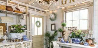 A garden shed adorned with blue-and-white chinoiserie pieces and winter greenery.