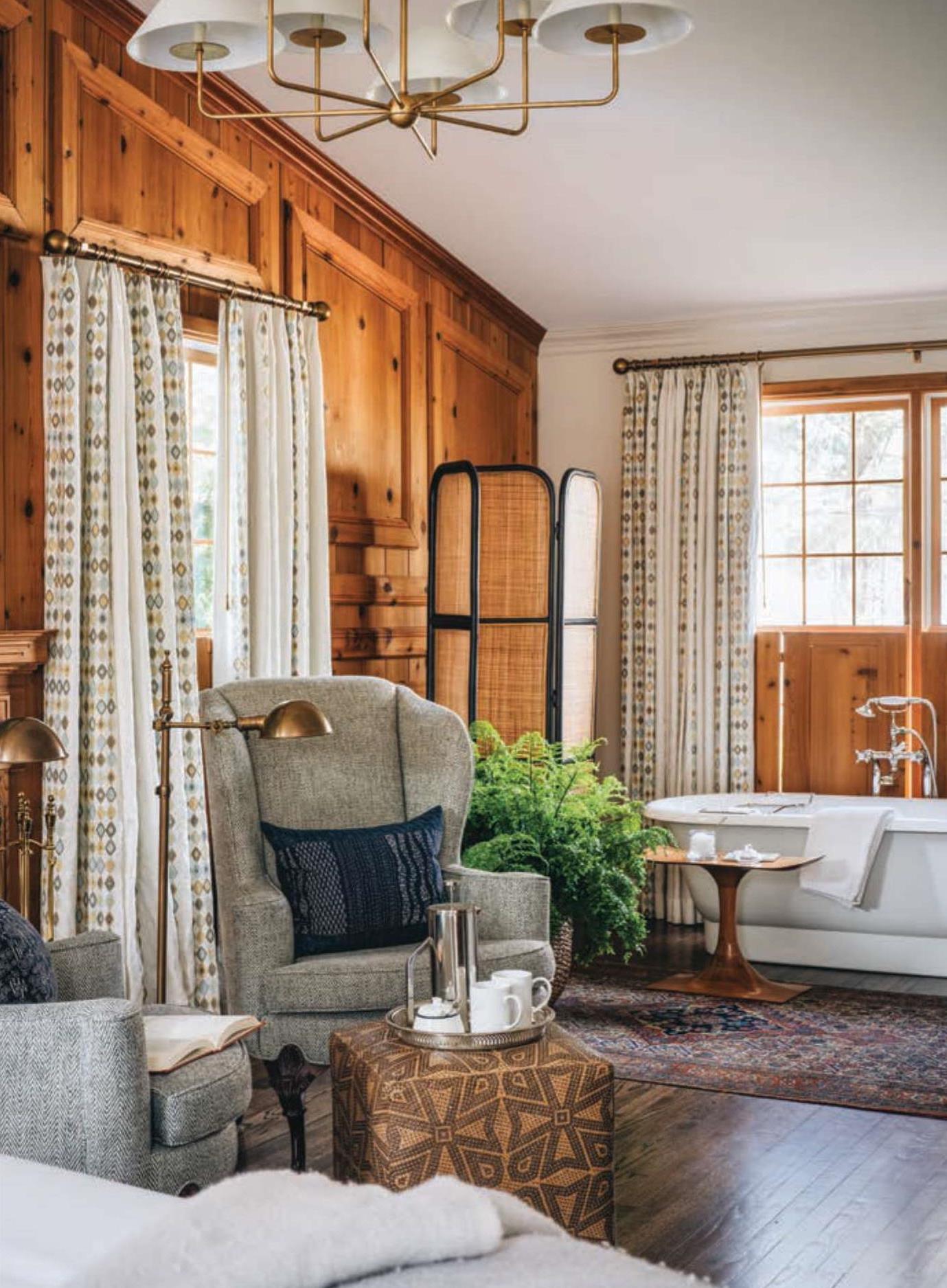 Guest suite at Wickwood Inn featuring a seating area set with coffee and a bathtub.