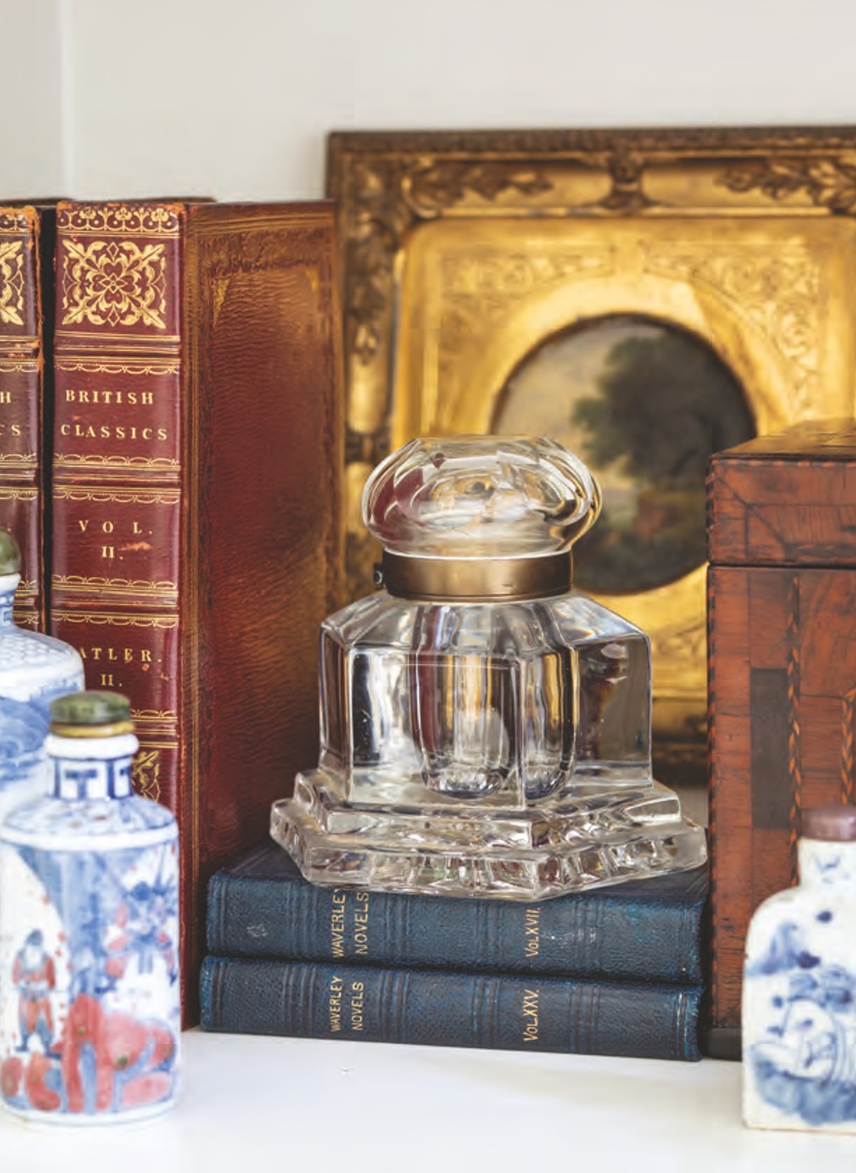 An antique inkwell with old books.