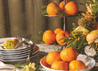 A tiered stand filled with tangerine oranges.